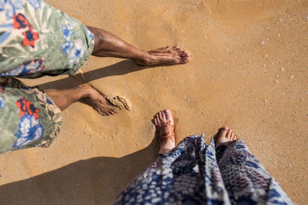 Angela & Tim's feet on the golden sandy Maui beach.