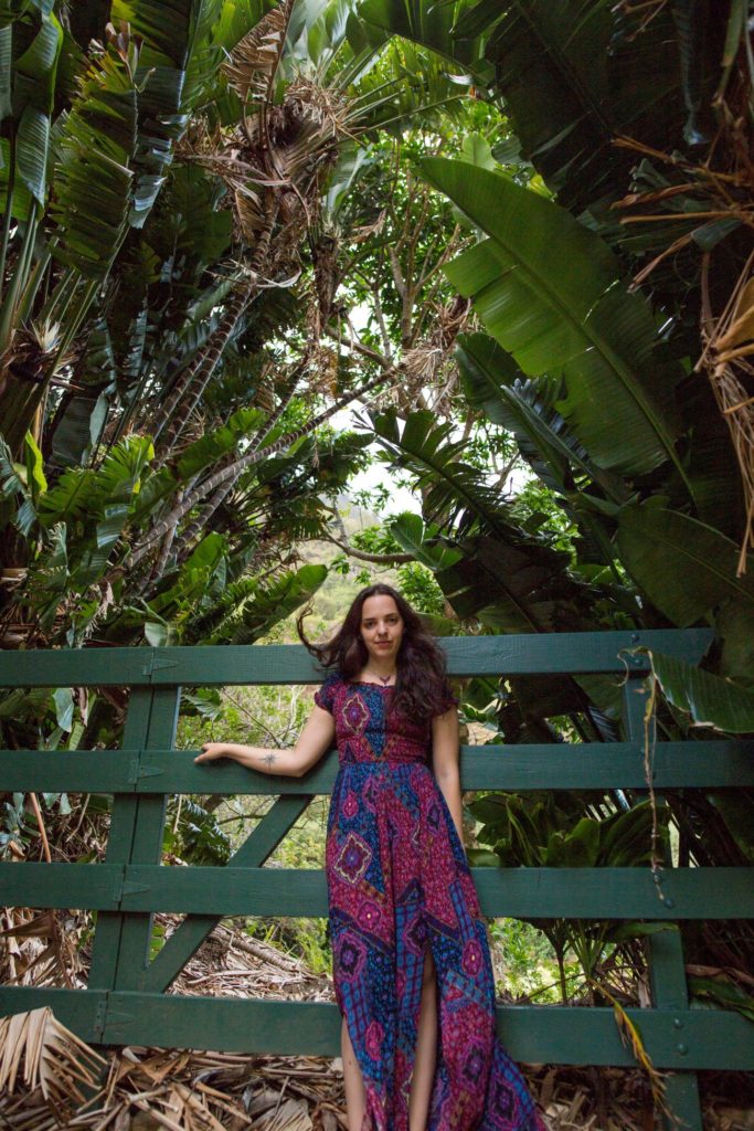 Angela in front of a lush backdrop in Maui, Hi along the Road to Hana.