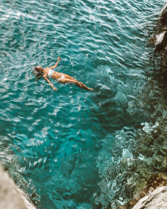 Elana floating in blue Maui waters
