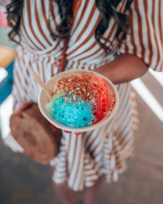 Shem holding a colorful shave ice in Maui Hawaii